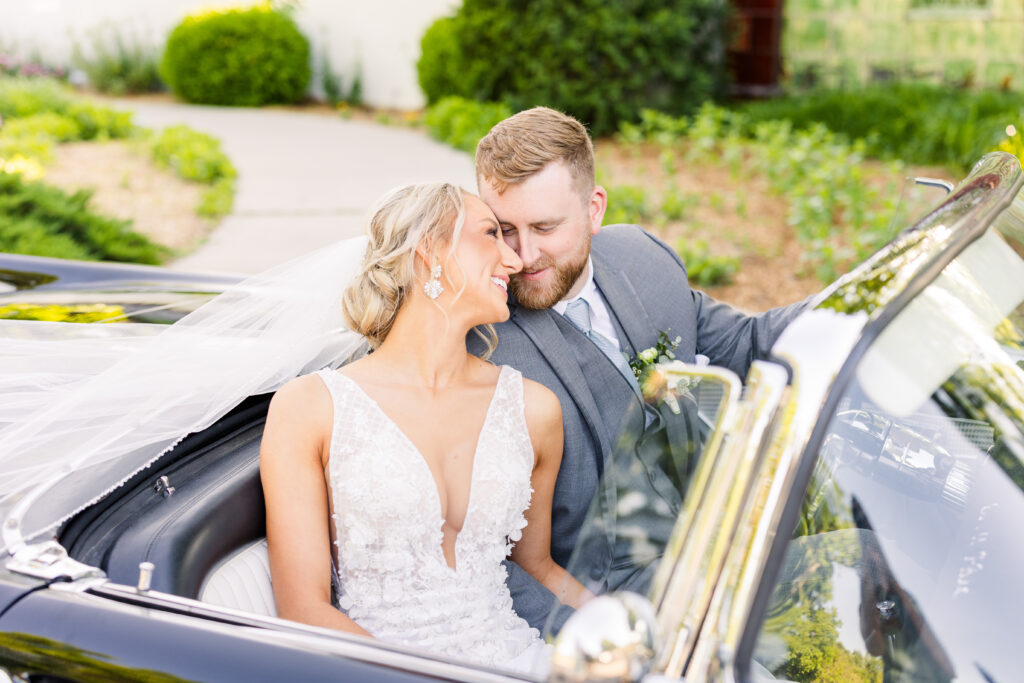 Bride and groom portraits with a convertible car