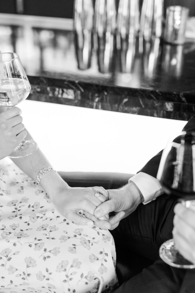 Couple enjoying drinks at the bara t a Kansas City getaway style engagement session