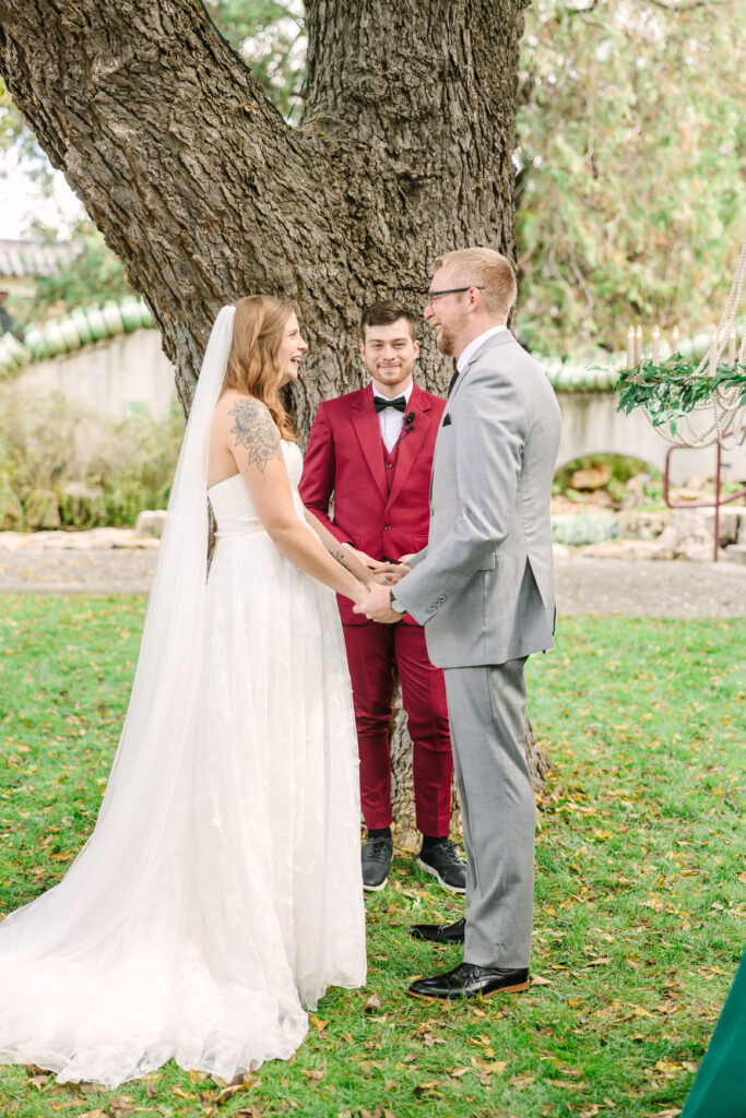Wedding officiant wearing a red suit at a non-traditional outdoor daytime wedding ceremony