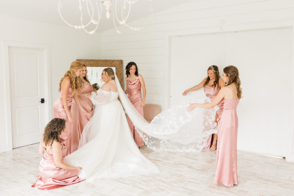 Bride and bridesmaids getting ready for wedding day in the bridal suite at The Barn at Grace Hill