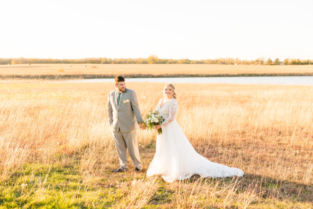Bride and groom posing outside in the hills outside of The Barn at Grace Hill